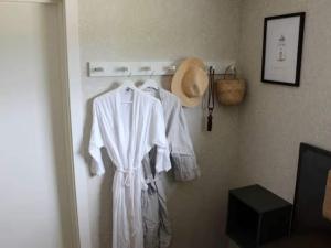 una bata blanca colgando en la pared en 4 person holiday home in LUR, en Lur