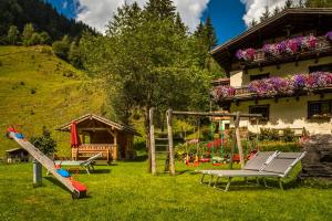a playground in a yard next to a house at Voglbach, Bauernhof in Rauris