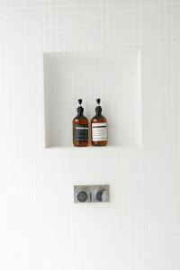 zwei Medikamentenflaschen auf einem Regal in einer Wand in der Unterkunft Villa Nevaeh - Ocean Front Private Villa Kamala Beach in Phuket