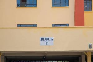 a block c sign on the side of a building at Fp&b apartments in Kisumu