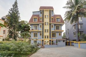 a tall building with a lot of windows at Hotel Orchard Nest - Pune Sinhgad Road in Pune