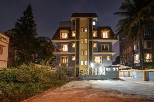 a large building at night with its lights on at Hotel Orchard Nest - Pune Sinhgad Road in Pune