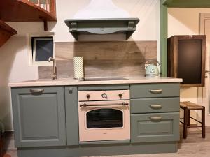 a kitchen with a stove and a sink at Casetta Margherita in Bisceglie