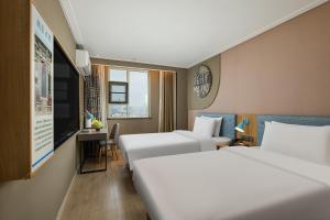 Ένα ή περισσότερα κρεβάτια σε δωμάτιο στο Urba Hotel Ganzhou Hongqi Avenue Branch +34 φωτογραφίες