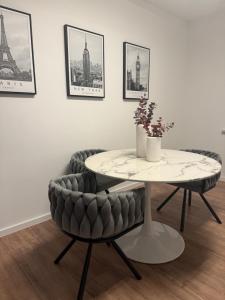 a table and chairs in a room with a table at Apartment Alana in Hannover +20 photos