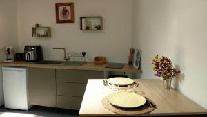 a kitchen with a counter and a table with a plate at kaz frangipanier in Entre-Deux