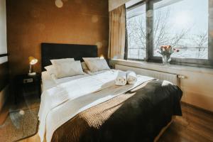 a bedroom with a bed with two shoes on it at VisitZakopane - Cristal Apartment in Zakopane +22 photos