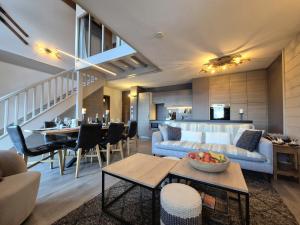 a living room with a couch and a table at Élégant Duplex - Sainte Foy Station - 10 pers in Sainte-Foy-Tarentaise