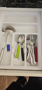 a white tray with utensils in a drawer at Casa próximo ao lago - 1 in Boa Esperança