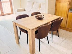 a wooden table and chairs in a living room at Casa da Serra - T1 - Penhas da Saúde in Penhas da Saúde