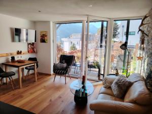 a living room with a couch and a table at #HeimatLiebe in Imst