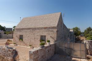 a stone building with a gate in front of it at Marinella Suite Home in Locorotondo