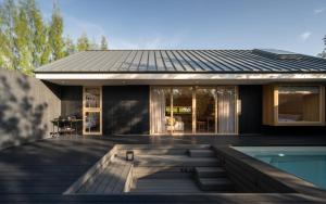 a house with a swimming pool in front of it at Kuro Pool Villa Khaoyai in Ban Wang Sai