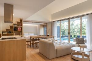 a living room with a couch and a table at Kuro Pool Villa Khaoyai in Ban Wang Sai