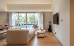 a living room with a white couch and a table at Kuro Pool Villa Khaoyai in Ban Wang Sai +38 photos