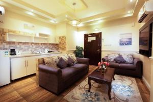 a living room with two couches and a table at Hotel Gardenz View 1 in Taif