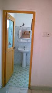 a bathroom with a white sink and a toilet at Private Beach House in Mirissa in Mirissa