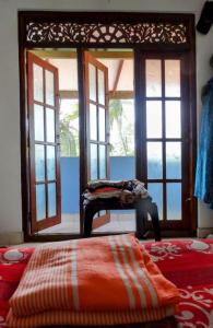 a bed in a room with windows and a bed sidx sidx sidx at Private Beach House in Mirissa in Mirissa