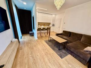 a living room with a couch and a table at Varpo 17 in Šiauliai