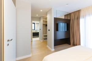 a bedroom with a white bed and a television at Luxury Villa Positiva in Vir +133 photos