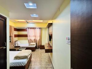 Postel nebo postele na pokoji v ubytování Hotel Anandam Residency