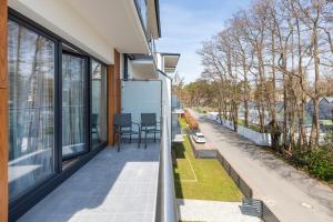 a balcony of a house with a view of a street at Charming Little Laguna Apartment with SPA & Fitness by Noclegi Renters in Międzywodzie