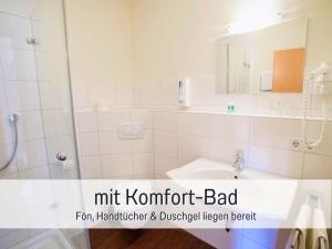 a bathroom with a sink and a shower and a mirror at Landgasthof Linde - In ruhiger, ländlicher Umgebung in Deggenhausertal +41 photos