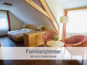 a bedroom with a bed and two chairs and a table at Landgasthof Linde - In ruhiger, ländlicher Umgebung in Deggenhausertal