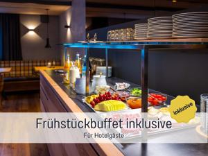 a buffet line with food and plates on a counter at Landgasthof Linde - In ruhiger, ländlicher Umgebung in Deggenhausertal