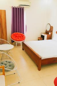 a bedroom with a bed and two chairs and a table at Bảo Anh Motel in Hải Dương +38 photos