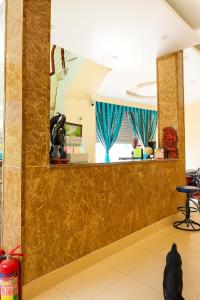 a lobby with a mirror and a dog statue at Bảo Anh Motel in Hải Dương