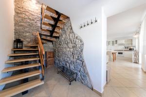 a staircase in a home with a stone wall at Vila Sistiana in Kostanjevica na Krasu