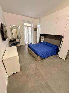 a bedroom with a bed with a blue comforter at B&B Il Corallo in San Benedetto del Tronto