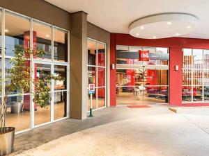 a lobby of a store with glass doors at ibis Blumenau in Blumenau