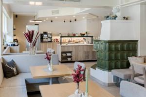 a restaurant with tables and chairs and a counter at Hotel Restaurant Platzer in Gmünd in Kärnten