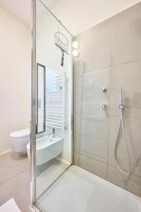 a bathroom with a glass shower with a sink and a toilet at Casa Mora in Cerro Lago Maggiore +13 photos