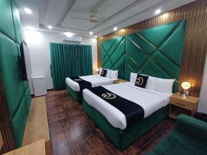 Postel nebo postele na pokoji v ubytování Grand Villa by Oslo Rezidor