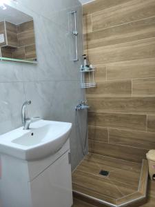a bathroom with a toilet and a sink and a shower at Michaniona apartment in Nea Michaniona +4 photos