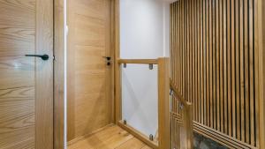 a glass door in a room with wooden walls at Rutherglen in Beaumaris +37 photos