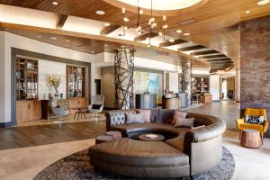 a living room with a couch and a table at Archer Hotel Florham Park in Florham Park