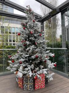 a christmas tree with presents under it in a building at Villa Westend Hotel an der Messe in Frankfurt/Main