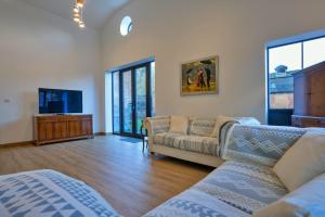 a living room with a couch and a tv at Finest Retreats - Courtyard View at Longford in Hollington