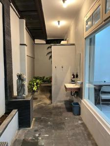 a bathroom with a sink and a window at Casavina residen kubu manyar 202 in Dalung