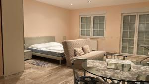 a bedroom with a bed and a chair and a table at Villa Valentina in Trpanj +42 photos