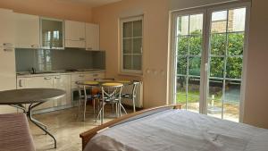 a bedroom with a bed and a table and a kitchen at Villa Valentina in Trpanj