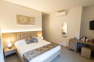 a hotel room with a bed and a television at Hotel Richard in Agliana