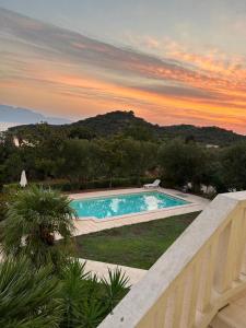 a swimming pool with a sunset in the background at Villa Valentina in Trpanj