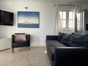 a living room with a couch and a chair at Villa near the ocean with private pool and garage in San Miguel de Abona