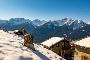 a snow covered roof with mountains in the background at Chalet Morge in La Salle