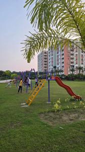 a group of playground equipment in a park at Spacious Lakeview Apartment with Balcony in Lucknow